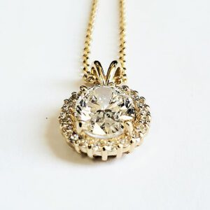 Gold chain with a diamond pendant.
