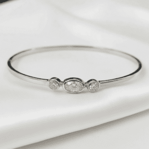 Silver bangle with three bezel-set diamonds
